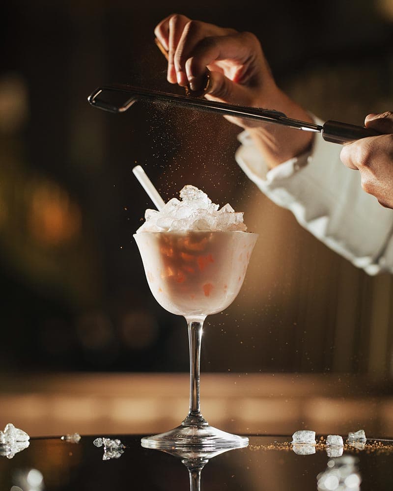 Vanda Mist cocktail, an orchid-garnished signature serve.